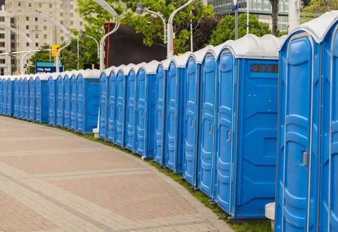 a row of portable restrooms at an outdoor special event, ready for use in Home